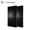 Two dark solar panels standing side by side on a white background, displaying grid lines and a slight tilt, with company logos in the top-left corner.